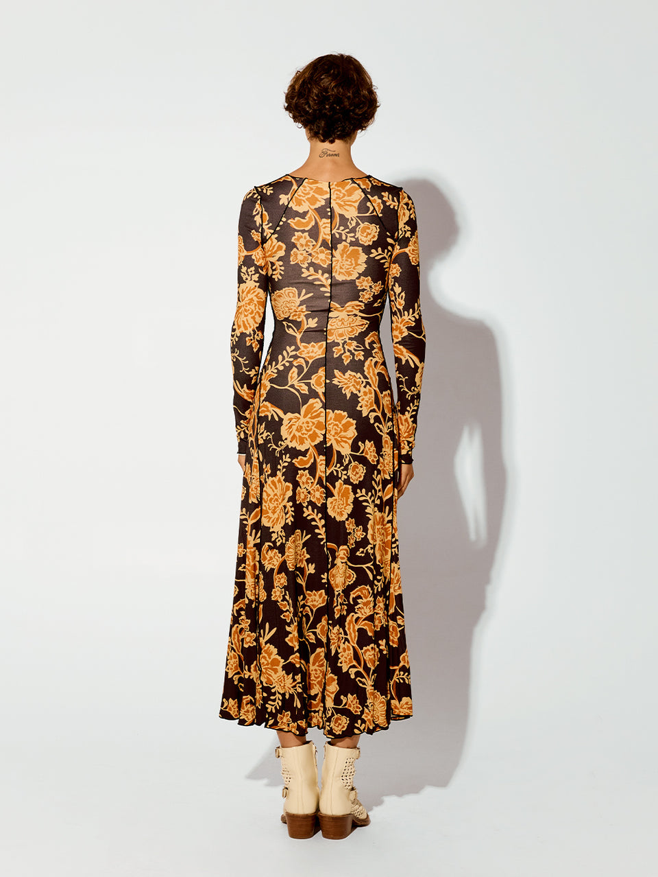 Kaia Knit Dress KIVARI | Model wears black and orange floral knit dress back view