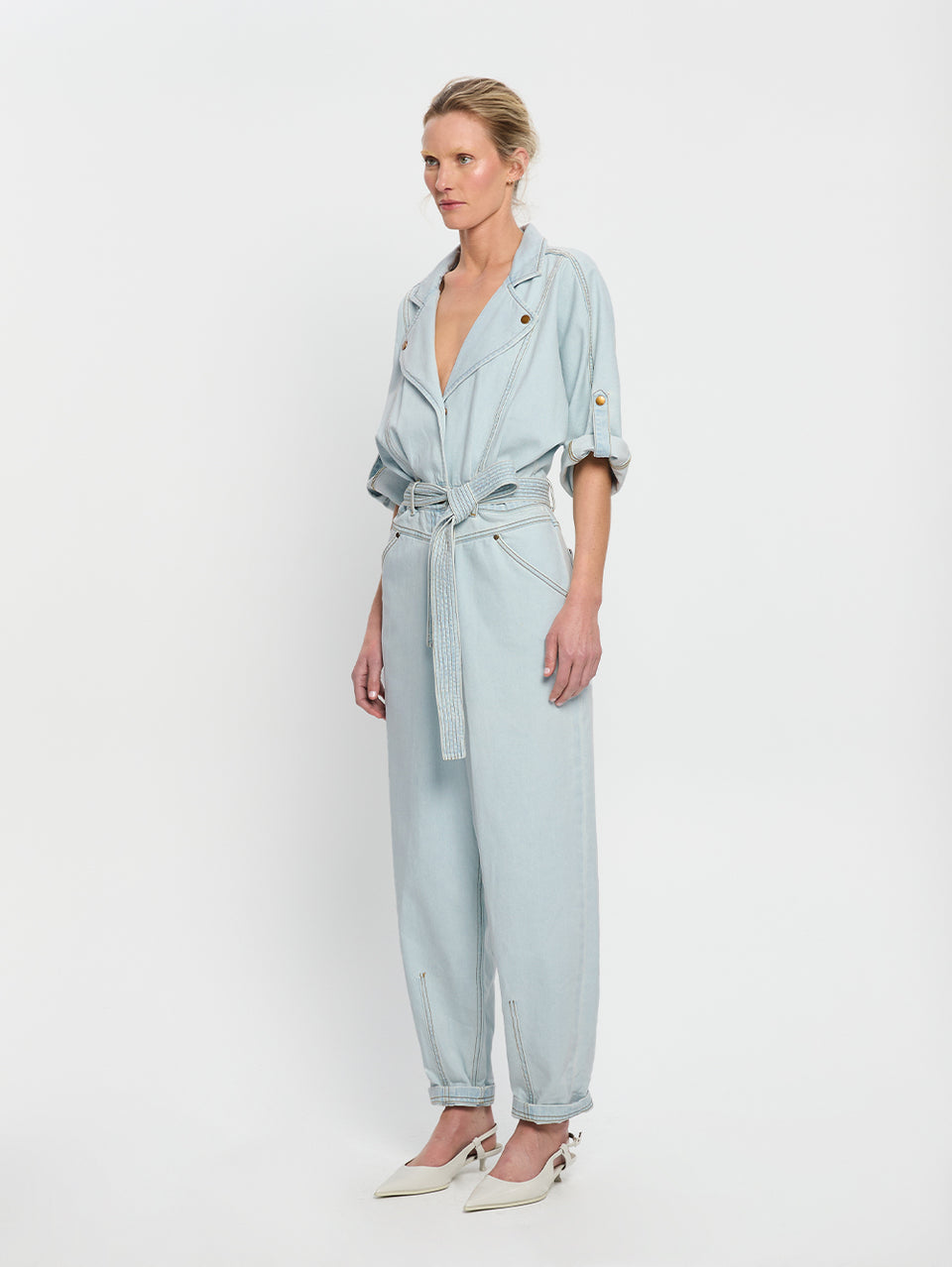 Adina Boilersuit Pale Blue KIVARI | Model wears light blue denim boilersuit side view