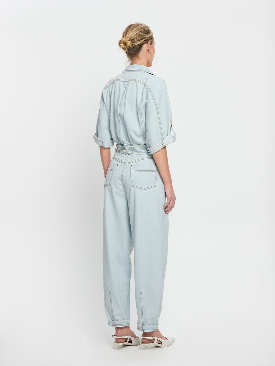 Adina Boilersuit Pale Blue KIVARI | Model wears light blue denim boilersuit back view