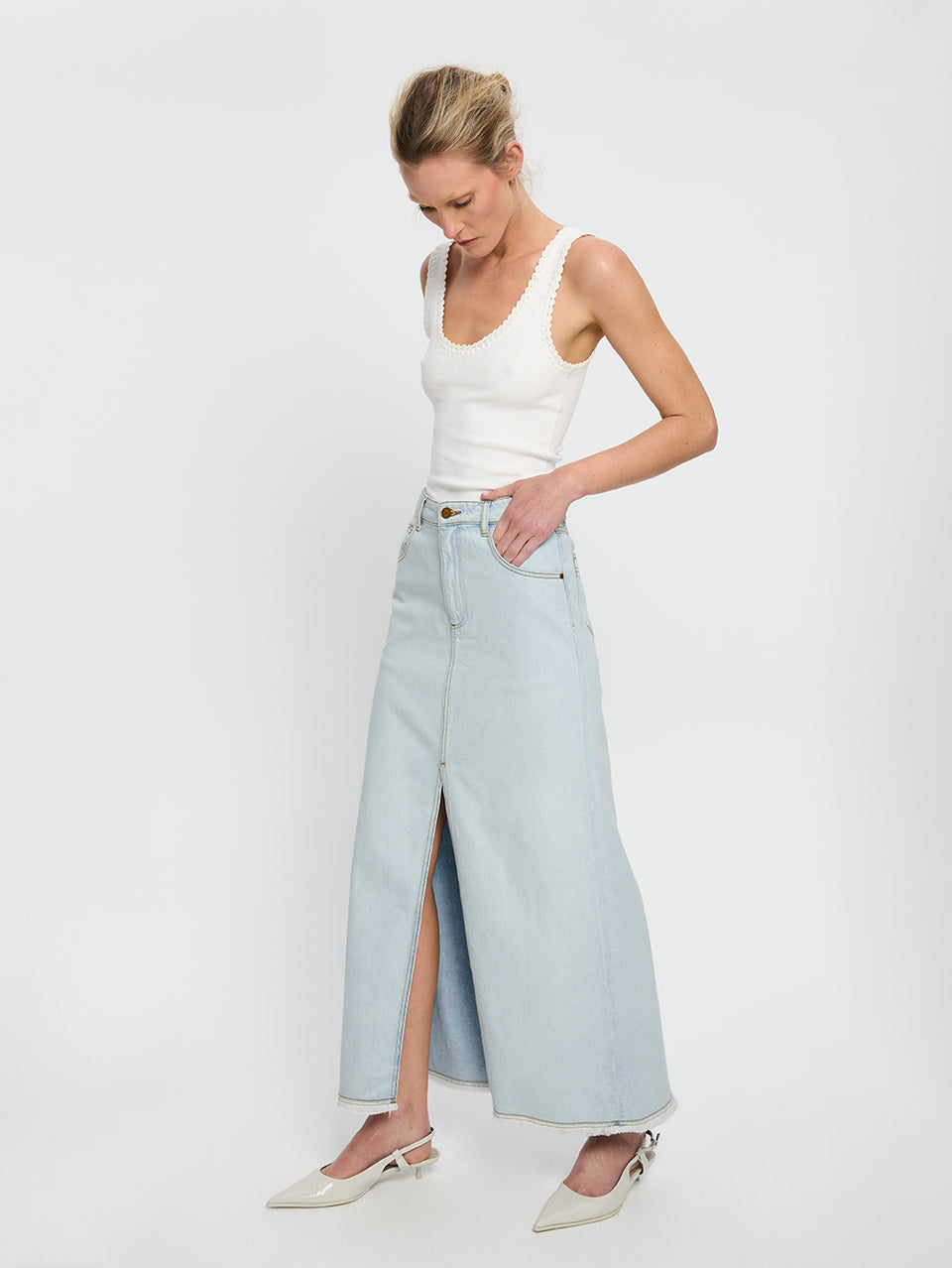 Zoya Skirt KIVARI | Model wears pale blue denim skirt side view