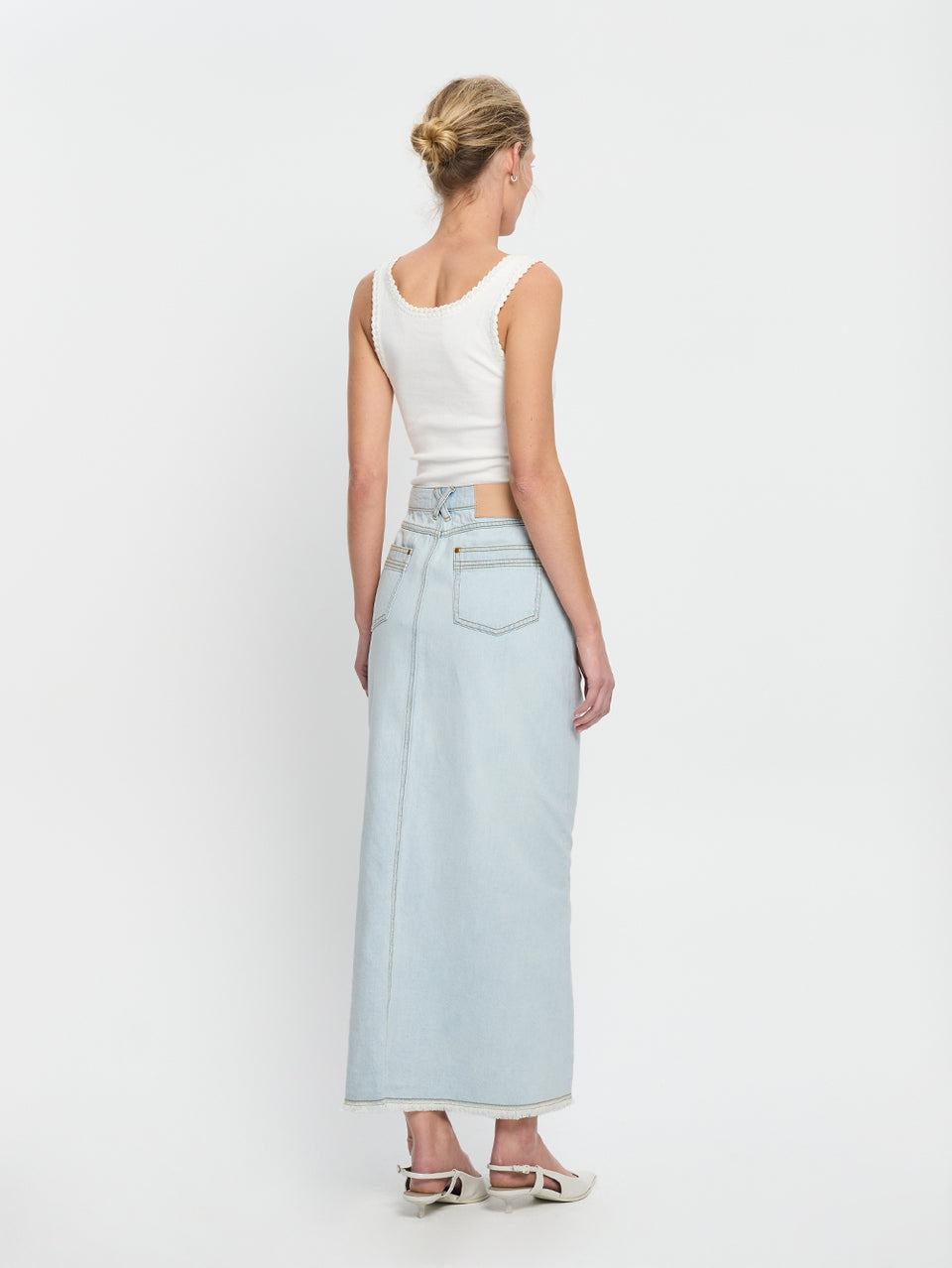 Zoya Skirt KIVARI | Model wears pale blue denim skirt back view