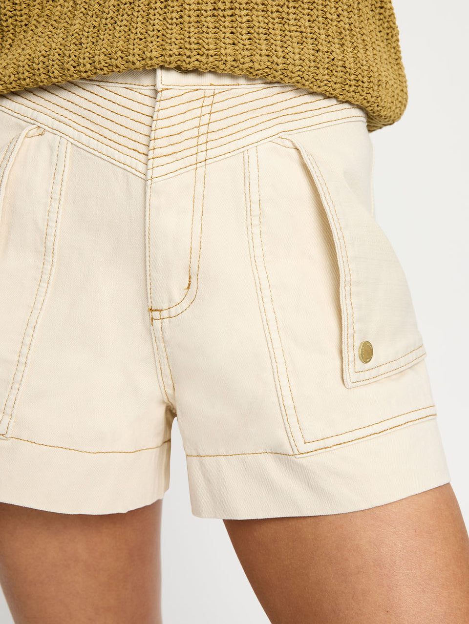 Celene Denim Short - Cream | Model wearing cream shorts with khaki knit cami